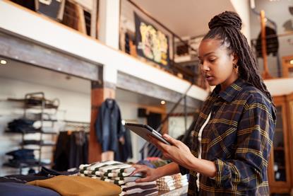 Retail worker checking stock in a clothes shop